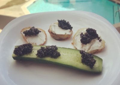 Organic cucumber with Sterlet Caviar. Fried potatoes with French cream and Sterlet on top